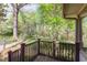 Back deck overlooking a private, treed backyard and lush landscaping at 660 Hembree Rd, Roswell, GA 30076