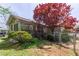 Single-story home featuring a fenced-in backyard and covered porch with stone steps at 660 Hembree Rd, Roswell, GA 30076