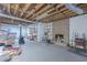 Unfinished basement featuring exposed beams, brick fireplace, and built-in shelving at 660 Hembree Rd, Roswell, GA 30076