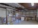 Unfinished basement featuring exposed framing, storage shelving, and mechanical equipment at 660 Hembree Rd, Roswell, GA 30076