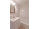 This bathroom offers a tub with a white tiled backsplash and a sink with a gold-trimmed mirror at 660 Hembree Rd, Roswell, GA 30076