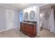 This bathroom features a double sink with dark brown cabinets and two mirrors above at 660 Hembree Rd, Roswell, GA 30076