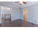 This bedroom features dark wood floors and is connected to another room via open doorways at 660 Hembree Rd, Roswell, GA 30076