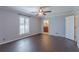 This bedroom features dark wood floors, a ceiling fan, one window and neutral colored walls at 660 Hembree Rd, Roswell, GA 30076