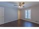 This bedroom features dark wood floors, a ceiling fan, one window and neutral colored walls at 660 Hembree Rd, Roswell, GA 30076