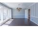 Elegant dining room with hardwood floors, chandelier, and large windows at 660 Hembree Rd, Roswell, GA 30076