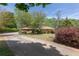 Charming single-story home with mature trees, landscaping, and a long driveway at 660 Hembree Rd, Roswell, GA 30076