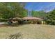 Well-maintained home with mature trees and landscaping at 660 Hembree Rd, Roswell, GA 30076
