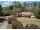 A large, landscaped front yard with a long driveway and various trees, showcasing the property's beauty at 660 Hembree Rd, Roswell, GA 30076