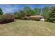 Spacious front yard featuring lush green grass and a variety of bushes, adding to the home's curb appeal at 660 Hembree Rd, Roswell, GA 30076