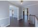 Open hallway with hardwood floors, white trim, and views into multiple rooms at 660 Hembree Rd, Roswell, GA 30076