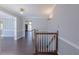 This hallway features dark wooden floors and is connected to multiple rooms via open doorways at 660 Hembree Rd, Roswell, GA 30076
