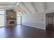Living room with vaulted ceiling, stone fireplace, hardwood floors, and lots of natural light at 660 Hembree Rd, Roswell, GA 30076