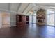 Living room with vaulted ceiling, stone fireplace, hardwood floors, and a large built-in bookshelf at 660 Hembree Rd, Roswell, GA 30076