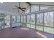 Enclosed sunroom with paneled ceiling, ceiling fan, and views of the landscaped yard at 660 Hembree Rd, Roswell, GA 30076