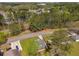 An aerial view of a home nestled among trees, featuring a driveway and a glimpse of the surrounding neighborhood at 1071 N Price Rd, Sugar Hill, GA 30518