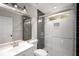 Modern bathroom featuring shower with patterned tile floor and stylish vanity with large mirror at 1071 N Price Rd, Sugar Hill, GA 30518