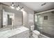 Modern bathroom with tile shower, grey floors, and marble vanity at 1071 N Price Rd, Sugar Hill, GA 30518