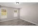 Bedroom with wood-look flooring and natural light streaming through windows at 1071 N Price Rd, Sugar Hill, GA 30518