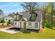 Charming home featuring eye-catching dormers, a new roof, and a bright yellow front door at 1071 N Price Rd, Sugar Hill, GA 30518