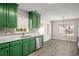 Bright kitchen featuring stainless steel dishwasher, sink, and vibrant green cabinets at 1071 N Price Rd, Sugar Hill, GA 30518