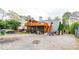 Back exterior of house with a wooden deck and a gravel yard containing storage and equipment at 1486 Harbins Rd, Norcross, GA 30093
