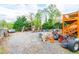 Large backyard area covered in gravel with storage, equipment, and a small shed at 1486 Harbins Rd, Norcross, GA 30093