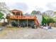 Exterior of home with a back deck, storage area, and gravel yard at 1486 Harbins Rd, Norcross, GA 30093