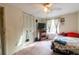 Standard bedroom featuring a ceiling fan, small window, and closet doors at 1486 Harbins Rd, Norcross, GA 30093