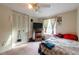 Simple bedroom featuring a bed, window and closet doors at 1486 Harbins Rd, Norcross, GA 30093