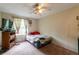 Simple bedroom with a ceiling fan, window and basic furnishings at 1486 Harbins Rd, Norcross, GA 30093