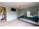 Modern bedroom featuring a ceiling fan, window, TV and closet at 1486 Harbins Rd, Norcross, GA 30093