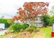 Lovely home with mature landscaping, a large tree, and a well-maintained lawn at 1486 Harbins Rd, Norcross, GA 30093