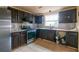 Kitchen showcasing stainless steel appliances, dark cabinetry, and tile floors at 1486 Harbins Rd, Norcross, GA 30093