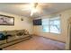 Inviting living room featuring a plush sofa, window views, and ceiling fan, perfect for relaxing or entertaining at 1486 Harbins Rd, Norcross, GA 30093