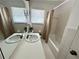 Bathroom featuring a large vanity, mirror, sink, tiled walls, bathtub, and shower at 5791 Warren Farm Sw Rd, Powder Springs, GA 30127