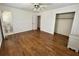 Bright bedroom featuring hardwood floors, ceiling fan, closet and ensuite bathroom at 5791 Warren Farm Sw Rd, Powder Springs, GA 30127