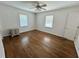 Bedroom featuring hardwood floors, ceiling fan, and natural light from the large windows at 5791 Warren Farm Sw Rd, Powder Springs, GA 30127