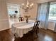 Formal dining room with hardwood floors, natural light, and view into the kitchen at 5791 Warren Farm Sw Rd, Powder Springs, GA 30127
