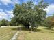 Long driveway lined with large trees leads to the house on a spacious lot at 5791 Warren Farm Sw Rd, Powder Springs, GA 30127