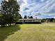 Ranch style home with a well-maintained lawn and mature trees at 5791 Warren Farm Sw Rd, Powder Springs, GA 30127