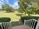 View from the porch, showcasing the lush, well-maintained front yard and mature trees at 5791 Warren Farm Sw Rd, Powder Springs, GA 30127