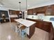 Open kitchen featuring a center island, custom cabinets, and views into the dining area at 5791 Warren Farm Sw Rd, Powder Springs, GA 30127