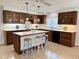 Stylish kitchen featuring custom wood cabinetry, a center island, and modern appliances at 5791 Warren Farm Sw Rd, Powder Springs, GA 30127