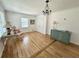 Bright living room featuring wood floors, chandelier, large window and mint dresser at 5791 Warren Farm Sw Rd, Powder Springs, GA 30127