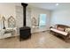 Cozy living room featuring a vintage stove, decorative accents, and ample natural light at 5791 Warren Farm Sw Rd, Powder Springs, GA 30127