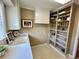 Walk-in pantry with open shelving, white cabinets, and a utility sink at 5791 Warren Farm Sw Rd, Powder Springs, GA 30127
