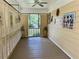 Enclosed porch with wooden floors, shuttered walls, and ceiling fan at 5791 Warren Farm Sw Rd, Powder Springs, GA 30127