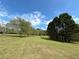 Expansive grassy yard with mature trees, offering a serene and private outdoor space at 5791 Warren Farm Sw Rd, Powder Springs, GA 30127