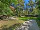 Expansive backyard featuring a stone patio with seating and a bocce court at 8 W Andrews Nw Dr, Atlanta, GA 30305